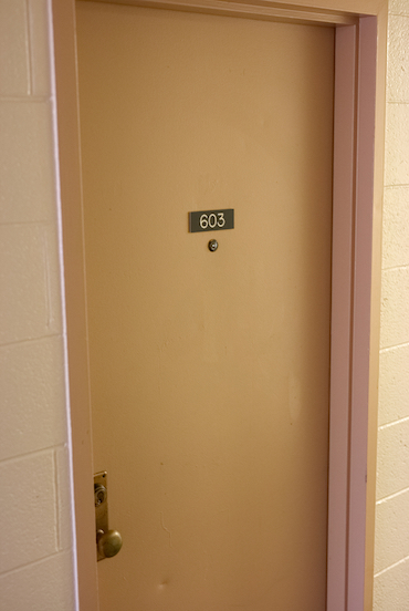 An image of a door with a 603 placard on it.
