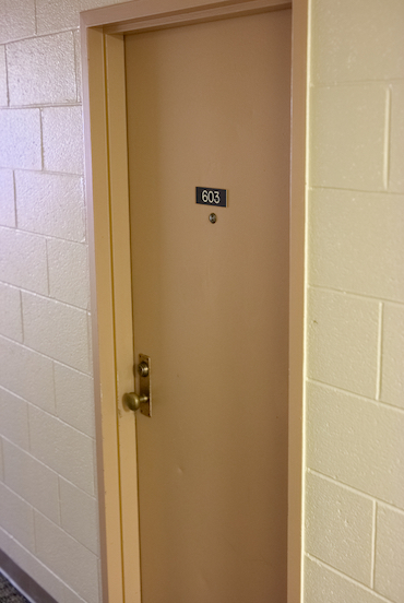 An image of a door with a 603 placard on it.